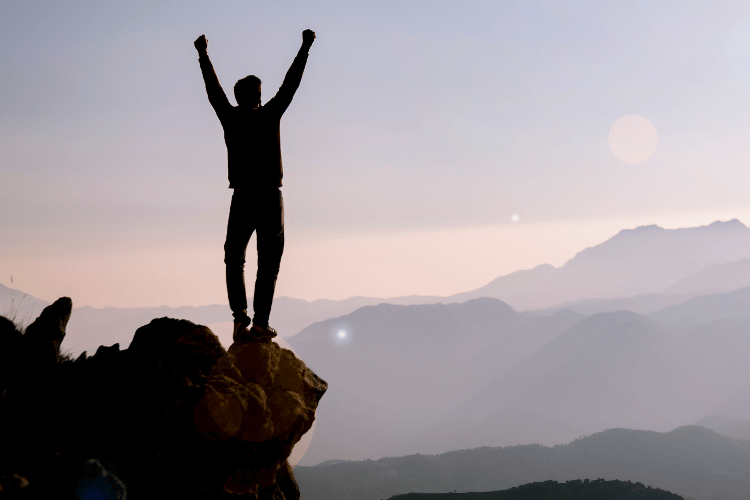 A happy man celebrating outdoors, goals achievement concept