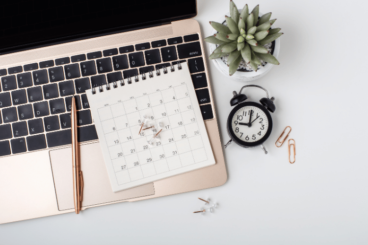 Top view of a calendar on a laptop on a white table